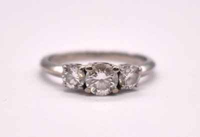 Lot 1099 - An 18ct white gold diamond three stone ring...