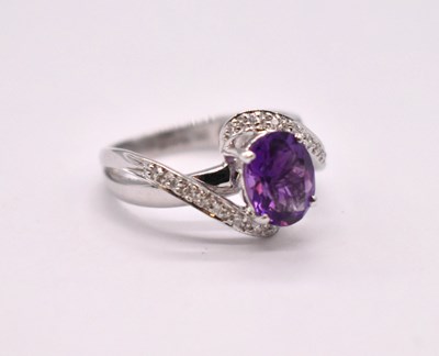 Lot 1108 - A 9ct white gold amethyst dress ring in swept...