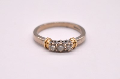 Lot 1110 - An 18ct yellow gold three stone diamond ring,...