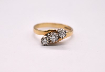 Lot 1112 - An 18ct yellow gold and diamond three stone...