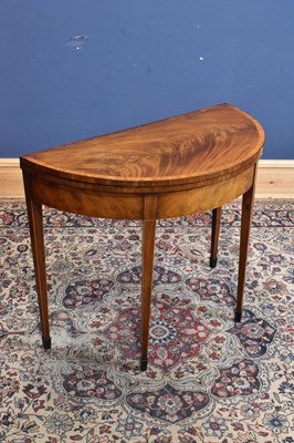 Lot 95 - A Georgian inlaid mahogany demi-lune fold-over...