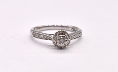 Lot 1126 - A 9ct white gold diamond set halo ring,...
