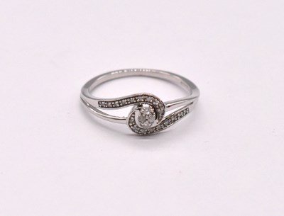 Lot 1128 - A 9ct white gold diamond set ring of swept...