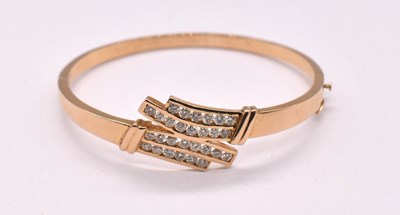 Lot 1132 - A 14ct yellow gold diamond set hinged oval...