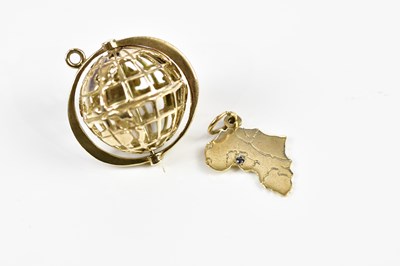 Lot 404 - A 9ct yellow gold pierced globe charm and a...