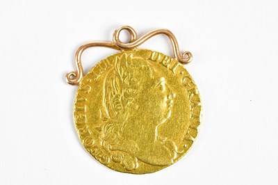 Lot 2549 - A George III guinea, now with yellow metal...