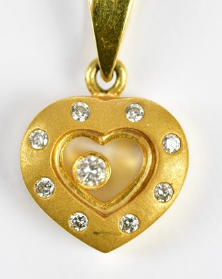 Lot 326 - An 18ct yellow gold flat link chain suspending...
