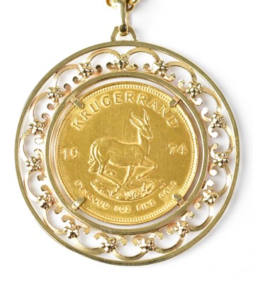 Lot 764 - A 1974 Krugerrand in a 9ct yellow gold floral...