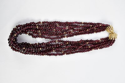 Lot 353 - A six strand garnet coloured beaded necklace...