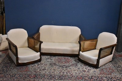 Lot 48 - A three piece Bergere suite with cream...