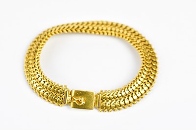 Lot 265 - An Eastern yellow metal bracelet with cast...