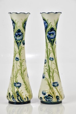 Lot 2186 - WILLIAM MOORCROFT; a pair of Florianware vases...