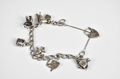 Lot 554 - A hallmarked silver charm bracelet, approx 30.4g.
