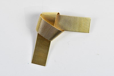 Lot 437 - A 14ct yellow gold textured tied knot brooch...