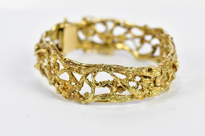 Lot 268 - A yellow metal textured openwork hinged snap...