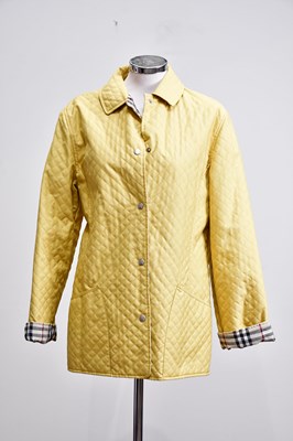 Lot 887 - BURBERRY; a mustard yellow quilted jacket with...