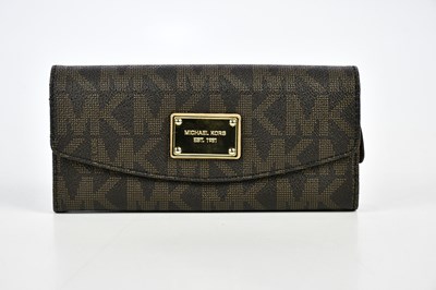Lot 831 - MICHAEL KORS; an unused brown Saffiano leather...