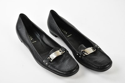 Lot 947 - PRADA; a pair of black pebbled leather flat...