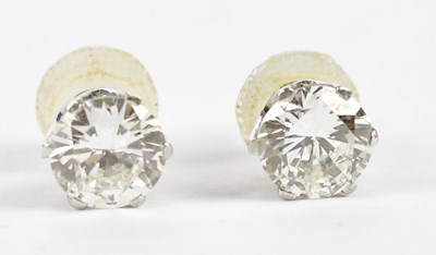 Lot 458 - A pair of white metal diamond ear studs, each...