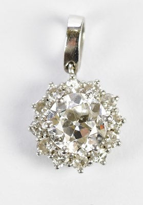 Lot 315 - A white metal diamond flowerhead pendant, the...