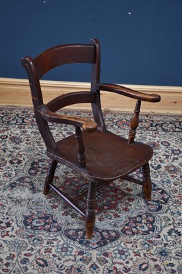 Lot 1083 - A 19th century elm seated elbow chair.