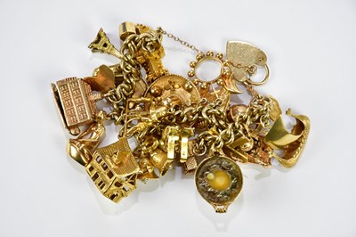 Lot 267 - A 9ct yellow gold charm bracelet with a good...