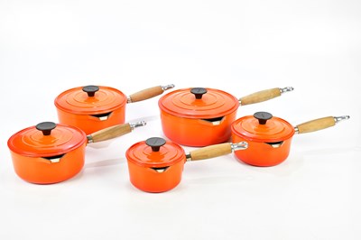 Lot 1201 - COUSANCES; a collection of orange cast iron pans.