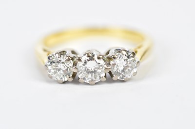 Lot 77 - An 18ct yellow gold three stone diamond ring,...