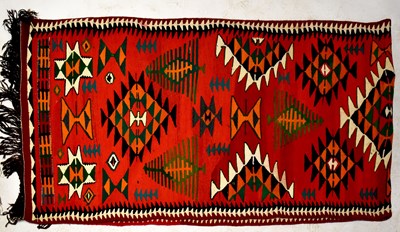 Lot 62 - An Iraqi Bedu red ground hand woven Kilim runner