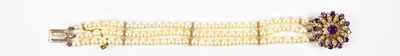 Lot 304 - A three strand cultured pearl bracelet with...