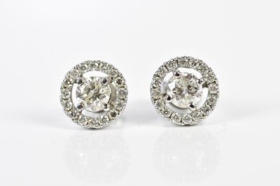 Lot 456 - A pair of 18ct white gold and diamond halo set...