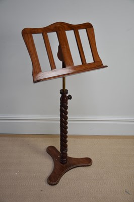 Lot 1140 - A reproduction adjustable mahogany music stand,...