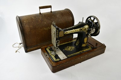 Lot 1405 - SINGER; an oak cased sewing machine.