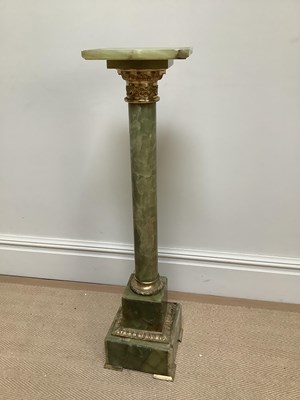 Lot 1224 - An onyx and gilt metal jardinière stand,...