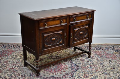 Lot 1086 - A 1920's oak sideboard, with two drawers above...