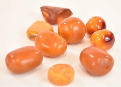 Lot 1271 - A group of loose egg yolk/butterscotch amber...