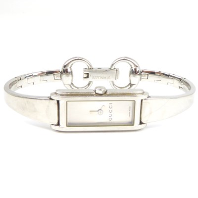 Lot 874 - GUCCI; a ladies' stainless steel tank-style...