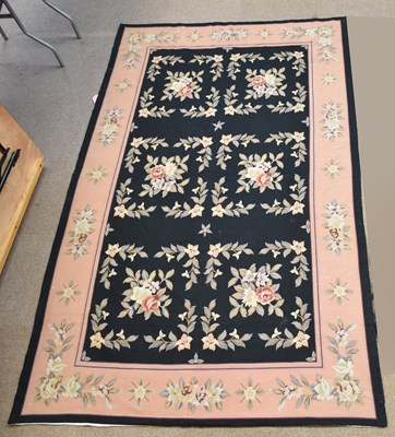 Lot 1208 - A tapestry carpet, worked with floral motifs...