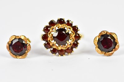 Lot 82 - An 18ct yellow gold garnet set dress ring,...