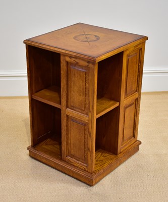 Lot 1107 - A reproduction inlaid oak revolving bookcase,...
