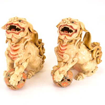 Lot 426 - Two ceramic Dogs of Fo, each holding a Satsuma-...