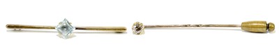 Lot 1448 - A yellow metal stick pin set with a diamond...