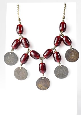 Lot 1011 - A Turkish cherry amber coloured bead necklace...