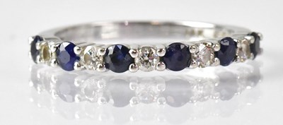 Lot 713 - A 14k white gold ring set with sapphires and...