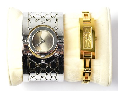 Lot 873 - GUCCI; a gold-coloured stainless steel...