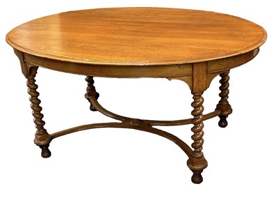 Lot 67 - An early 20th century oak oval dining table on...
