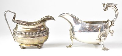 Lot 602 - A white metal sauce boat raised on three...