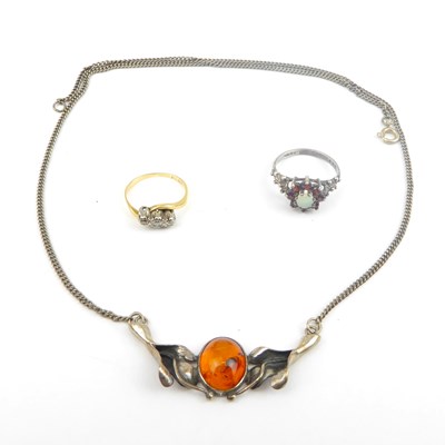 Lot 827 - A gold ring set with three tiny diamonds, size...