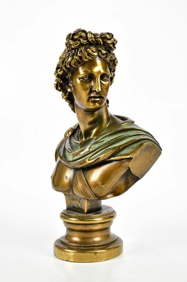 Lot 1455 - A decorative bronzed bust of Apollo, on socle,...