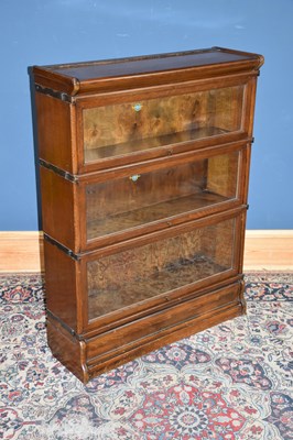 Lot 1022 - GLOBE WERNICKE; an oak three tier stacking...